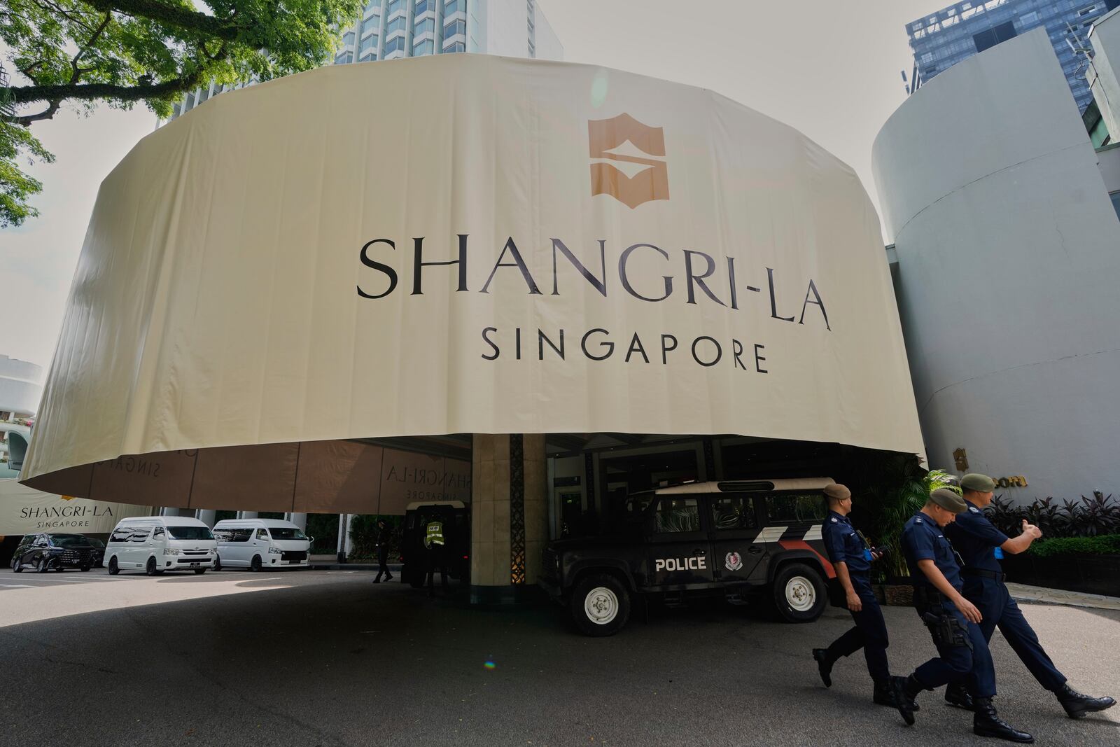 Police officials walk past the venue during the Shangri-La Dialogue summit in Singapore, Friday, May 30, 2025. (AP Photo/Anupam Nath)