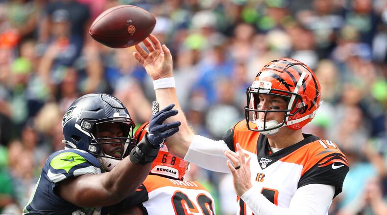 SEATTLE, WASHINGTON - SEPTEMBER 08: Andy Dalton #14 of the Cincinnati Bengals throws the ball against Rasheem Green #98 of the Seattle Seahawks in the second quarter during their game at CenturyLink Field on September 08, 2019 in Seattle, Washington. (Photo by Abbie Parr/Getty Images)