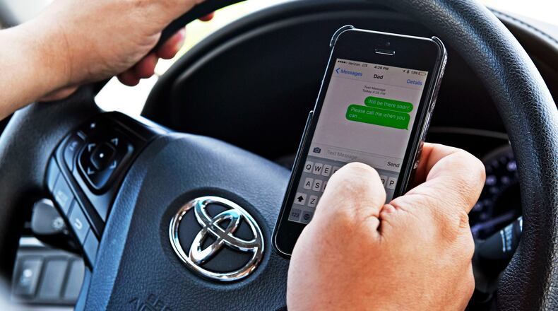 House Bill 95 makes distracted driving a secondary offense that can result in a fine of up to $100. This means that drivers must be pulled over first for a moving violation before being cited for the offense. Under the bill, distractions include — but aren’t limited to — texting, reading, using tablet or smart phone features, or applying make-up. Photo Illustration by NICK GRAHAM/STAFF