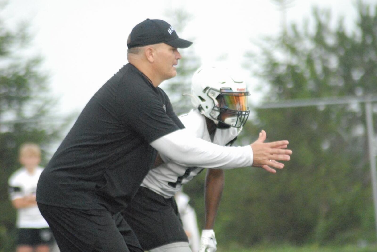 Lakota East football coach Jon Kitna runs a play during a recent practice. Chris Vogt/CONTRIBUTED