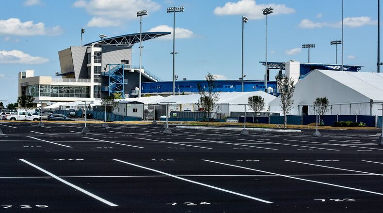 Improvements have been made to the Lindner Family Tennis Center in Mason, including more paved parking lot spaces and grading and drainage work to surface lots surrounding the complex with gravel driving lanes and walking paths to improve pedestrian and vehicle access. The Western & Southern Open tennis tournament runs Aug. 12 through Aug. 20. NICK GRAHAM/STAFF