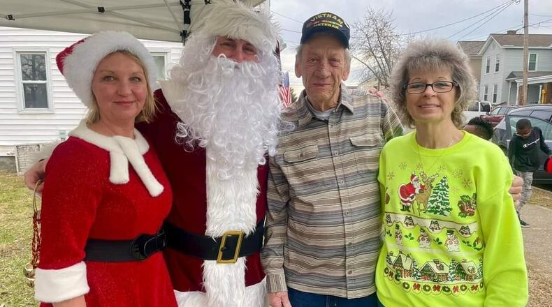 Toni and Ray Moore, right, are seen with Scott and Lauren Smallwood, left, who played Santa and Mrs. Claus during Operation North End Pole in Hamilton. The Moores are big contributors to the North End Community and have operated a market on Vine Street for more than 40 years. CONTRIBUTED