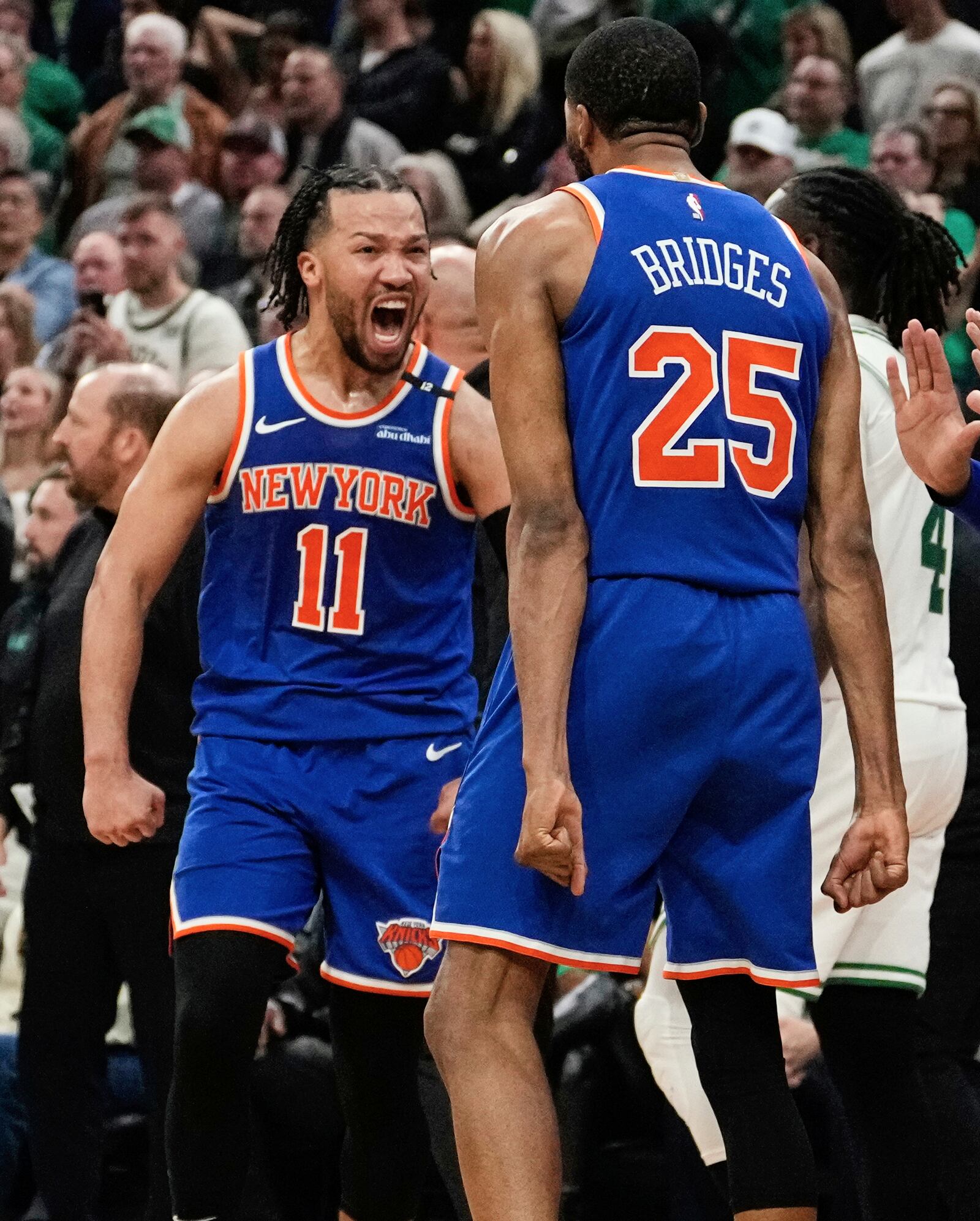 New York Knicks guard Jalen Brunson (11) celebrates with Mikal Bridges (25) after defeating the Boston Celtics in Game 1 of an NBA basketball second-round playoff series Monday, May 5, 2025, in Boston. (AP Photo/Charles Krupa)