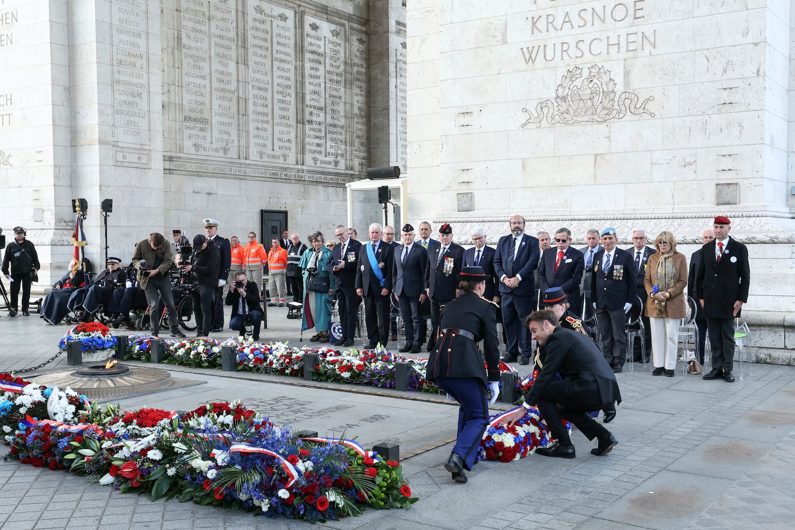 French President Emmanuel Macron, right, lays a wreath at the Tomb of the Unknown soldier during ceremonies marking the 80th anniversary of the end of World War II in Europe, Thursday May 8, 2025 in Paris. (Thomas Samson, Pool via AP)