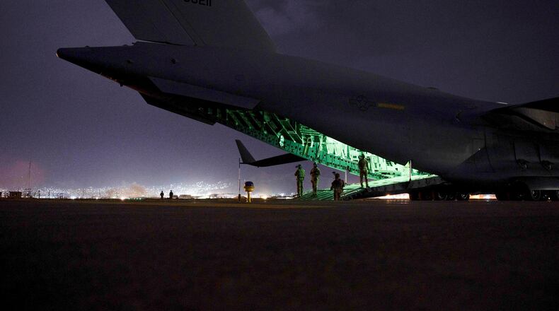 FILE - In this photo provided by the U.S. Air Force, an Air Force aircrew, assigned to the 816th Expeditionary Airlift Squadron, prepares to receive soldiers, assigned to the 82nd Airborne Division, to board a U.S. Air Force C-17 Globemaster III aircraft in support of the final noncombatant evacuation operation missions at Hamid Karzai International Airport in Kabul, Afghanistan on Aug. 30, 2021. The U.S. airlifted 124,000 people out of Kabul over about six weeks as the American-backed Afghan military and government fell to the Taliban. (Senior Airman Taylor Crul/U.S. Air Force via AP, File)