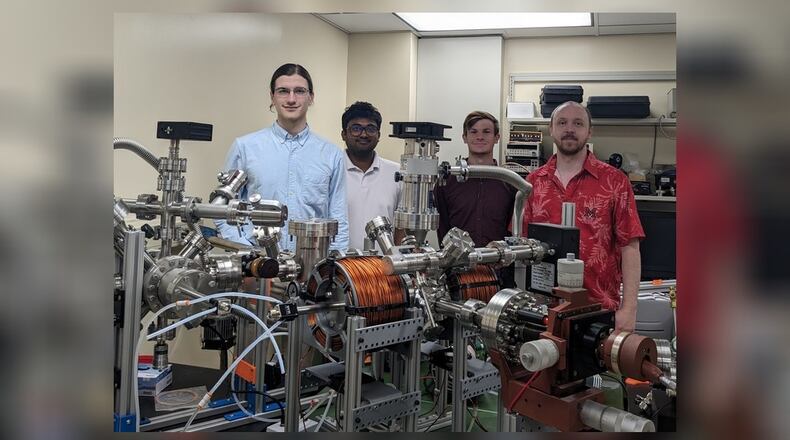 From left, Miami University students Carter Wade, Lakshan Don Manuwelge Don, Nate Price and Dr. Joseph Perry Corbett, tested the newly installed ultra-high vacuum scanning tunneling microscope at Miami University in Oxford. The microscope was donated by the Air Force Research Laboratory Materials and Manufacturing Directorate to the Corbett Research Group as part of a recently signed Educational Partnership Agreement with Miami. RANNET MANNING/CONTRIBUTED