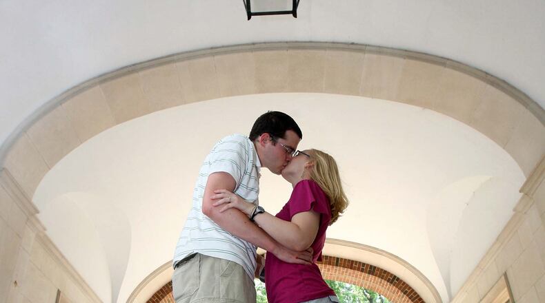 Stephanie Reid and Nick Hieber kiss under the Upham Arch in 2009. Legend states you will marry the person you kiss under the lantern inside the arch of Upham Hall at midnight. STAFF FILE PHOTO/2009
