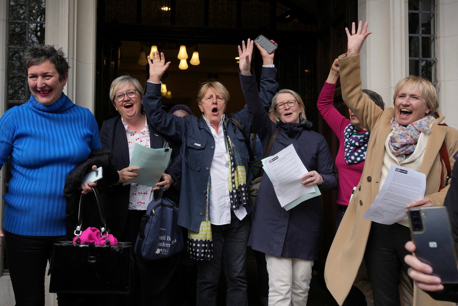 Women's rights activists celebrate outside the Supreme Court to challenge gender recognition laws, in London, Wednesday, April 16, 2025. (AP Photo/Kin Cheung)