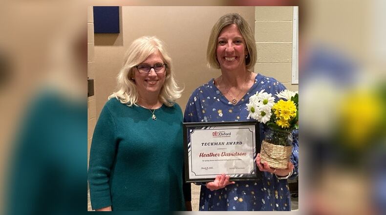 Bogan kindergarten teacher Heather Davidson (right) was the recipient of the Harry and Virginia Teckman Excellence in Education Award. Presentation was made at the Talawanda Board of Education meeting March 17 by Betsy Hope, executive director of the Greater Oxford Community Foundation. CONTRIBUTED