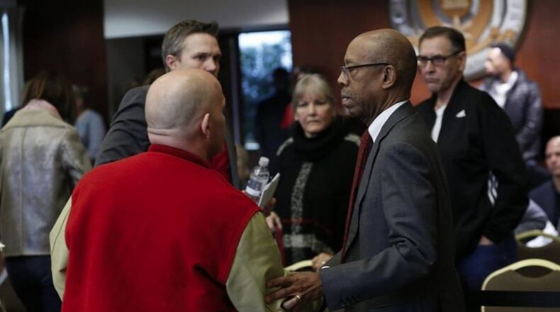 Ohio State president Michael Drake shakes hands with Michael DiSabato following his testimony about Dr. Richard Strauss during an Ohio State University Board of Trustees meeting at the Longaberger Alumni House on Nov. 16, 2018. ADAM CAIRNS/THE COLUMBUS DISPATCH