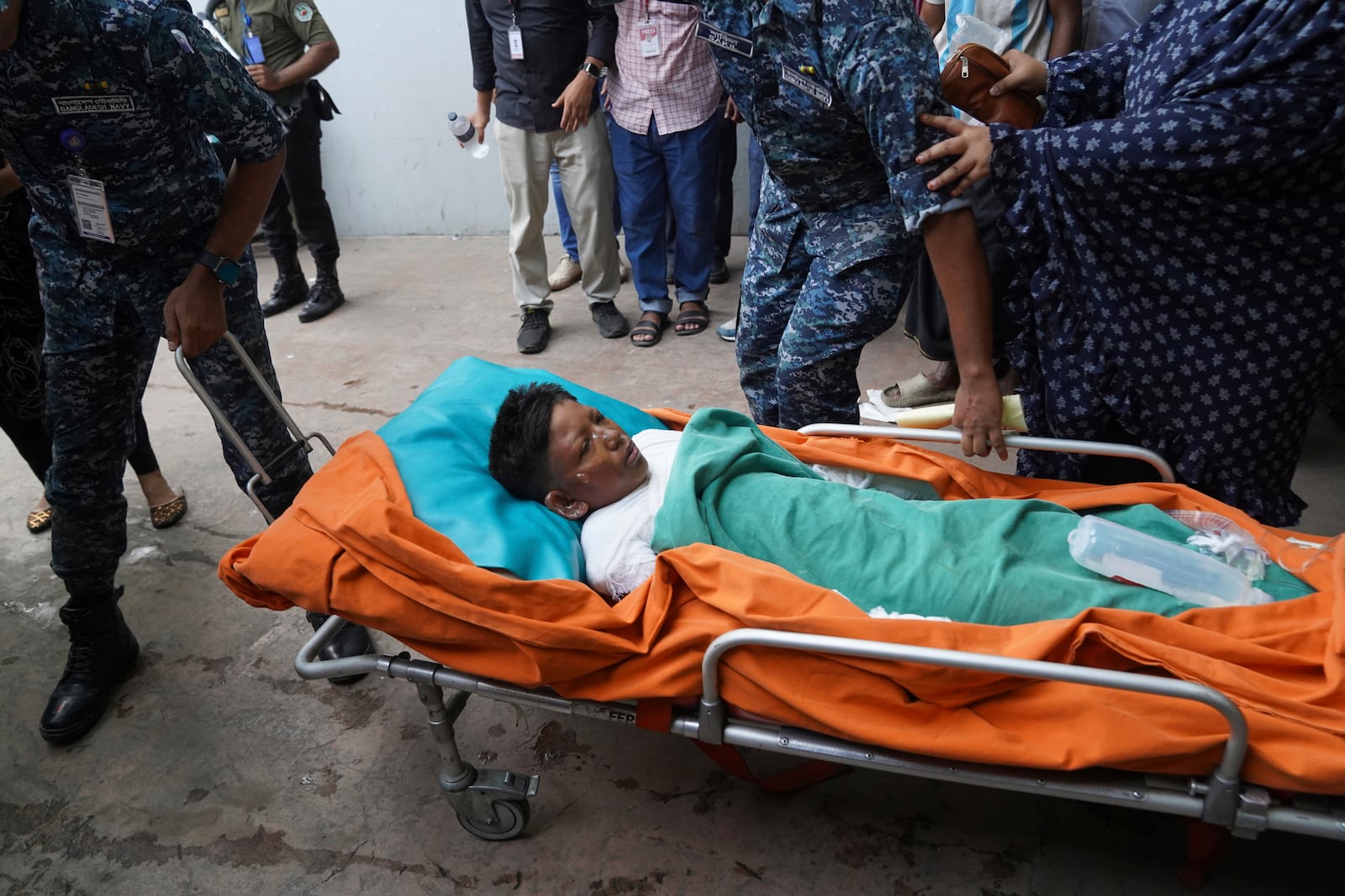 An injured victim in the Bangladesh Air Force aircraft crash lies on a stretcher at a hospital in Dhaka, Bangladesh, Monday, July 21, 2025. (AP Photo/Ahadul Karim Khan)