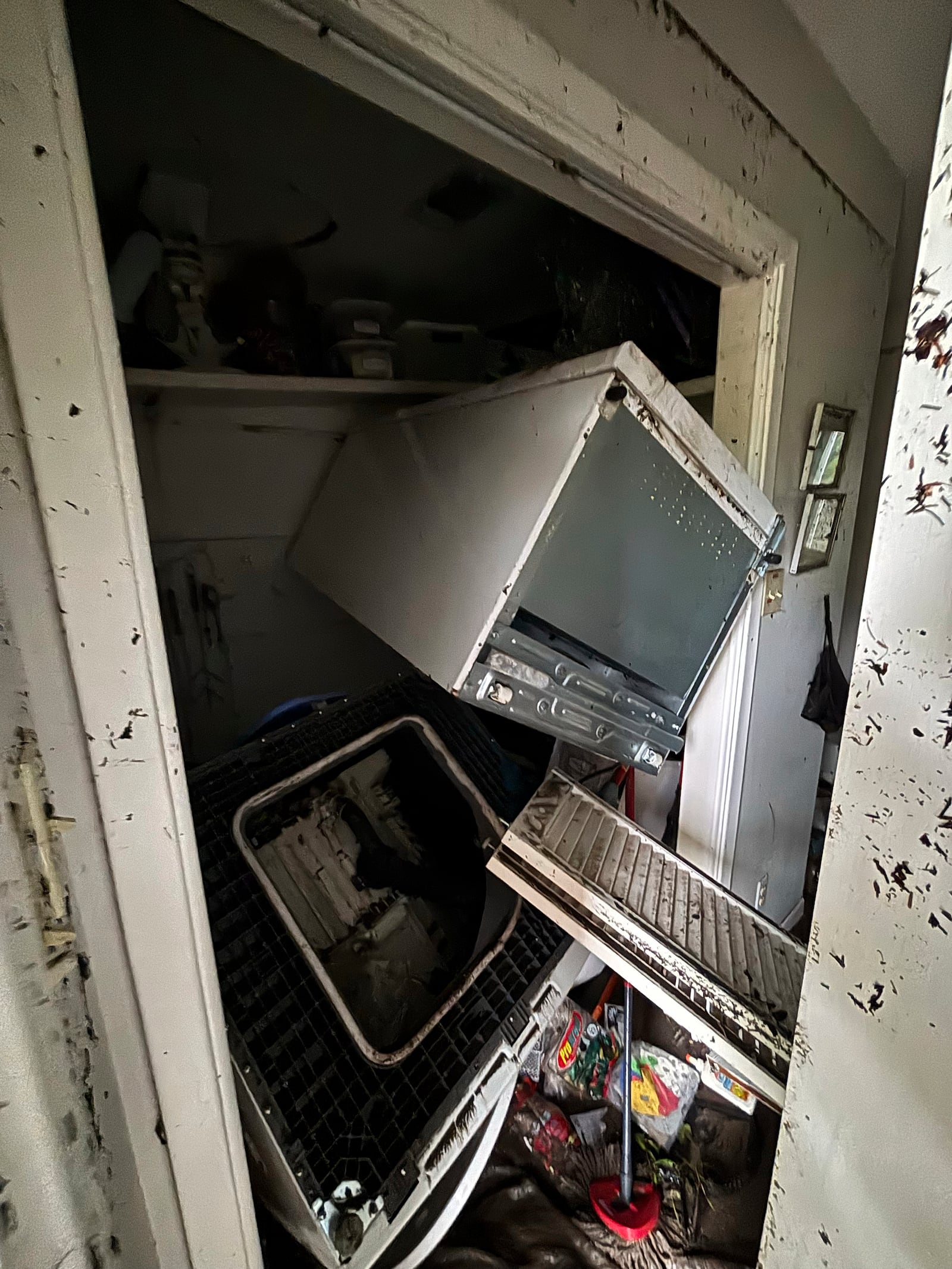 Appliances are piled up in Alden Towler's cabin in Hunt, Texas, at 2:35 p.m. on Friday, July 4, 2025, after floodwaters from the Guadalupe River devastated the town. (Alden Towler via AP)