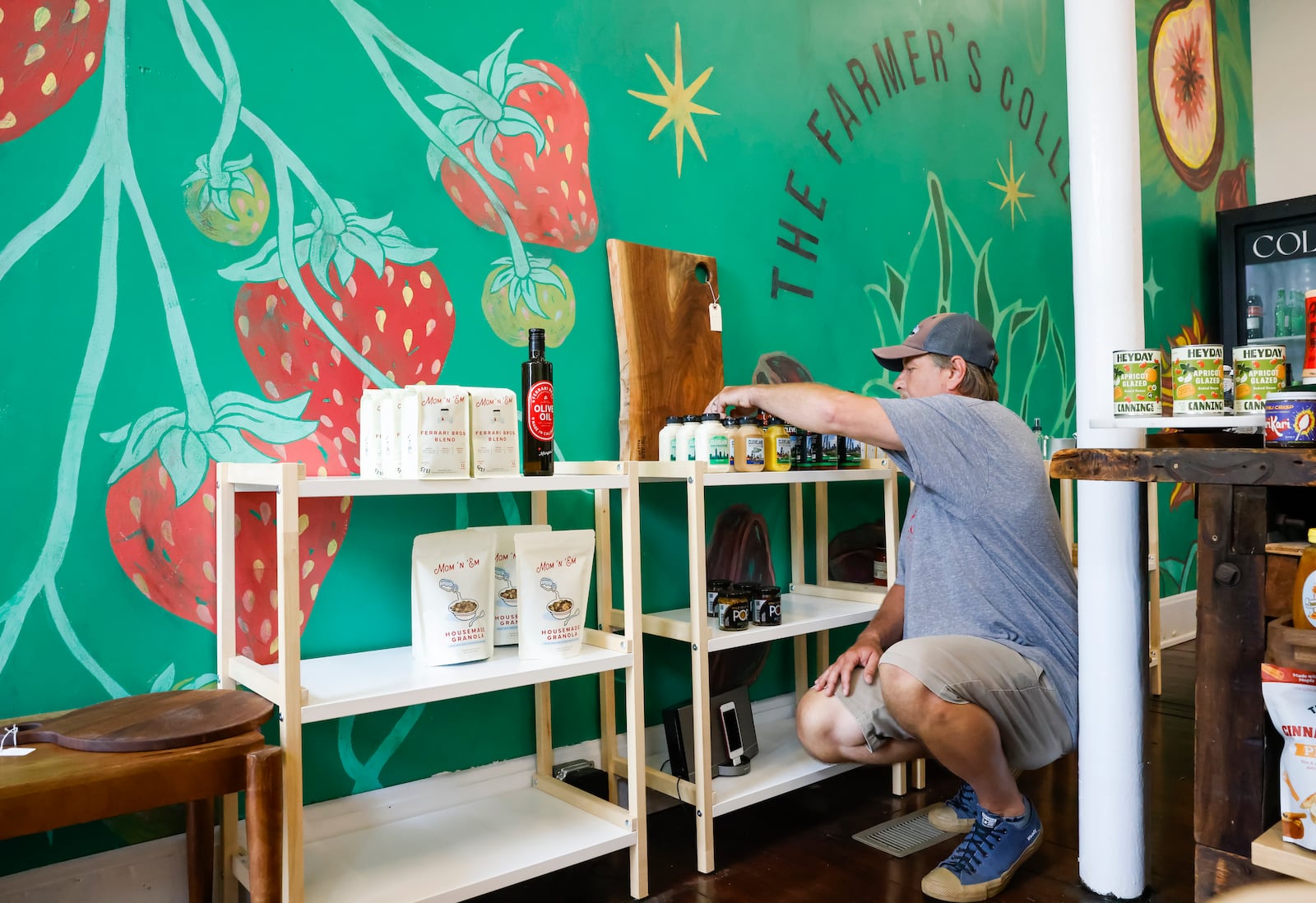 Josh Staton organizes products at The Farmer's Collective at 302 Main Street Thursday, June 26, 2025 in Hamilton. NICK GRAHAM/STAFF