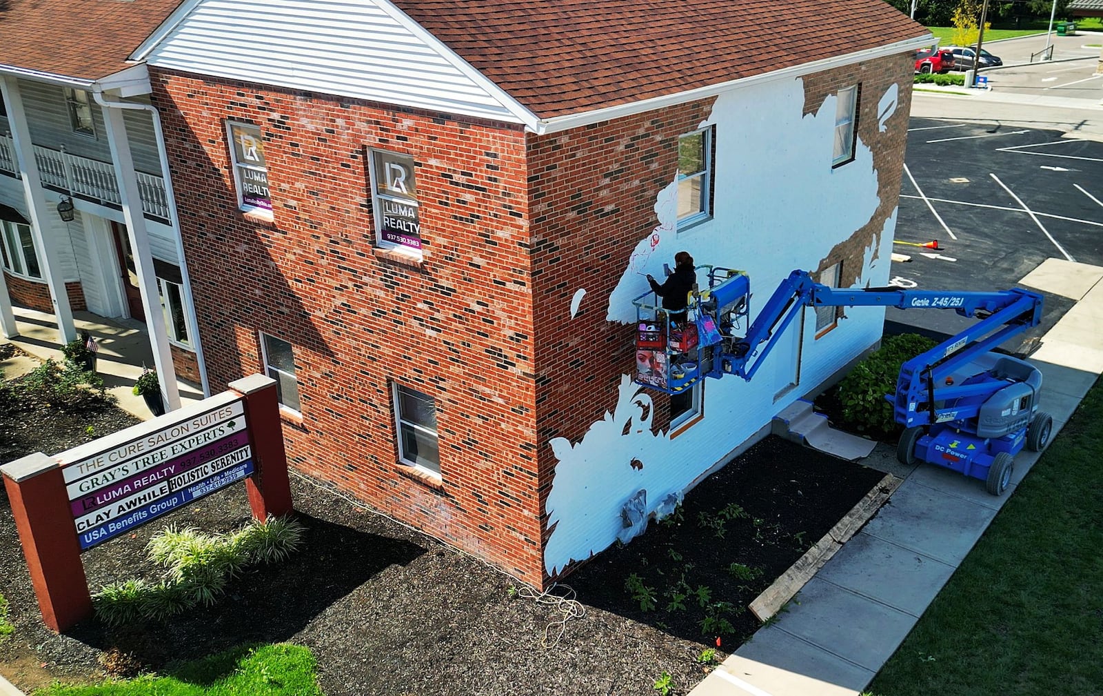 Spanish artist Lula Goce is in town painting Springboro's first public mural on the side of a building at 15 S. Main Street. Goce has traveled all over the world creating large wall murals. NICK GRAHAM/STAFF