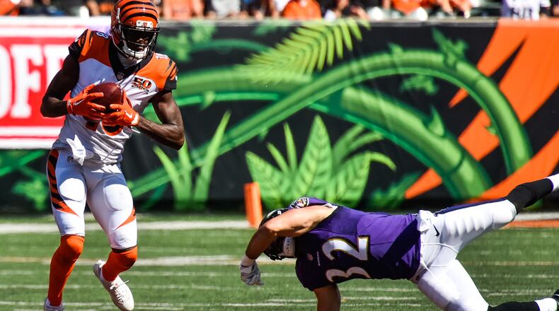The Cincinnati Bengals wide receiver A.J. Green makes a catch as Baltimore safety Eric Weddle dives to grab him at Paul Brown Stadium in Cincinnati. The Bengals on Friday signed Green to a one-year deal. NICK GRAHAM/STAFF
