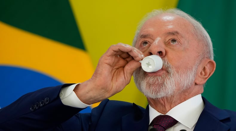 Brazilian President Luiz Inacio Lula da Silva takes a sip of coffee during a year-end press conference at Planalto presidential palace in Brasilia, Brazil, Thursday, Dec. 18, 2025. (AP Photo/Eraldo Peres)