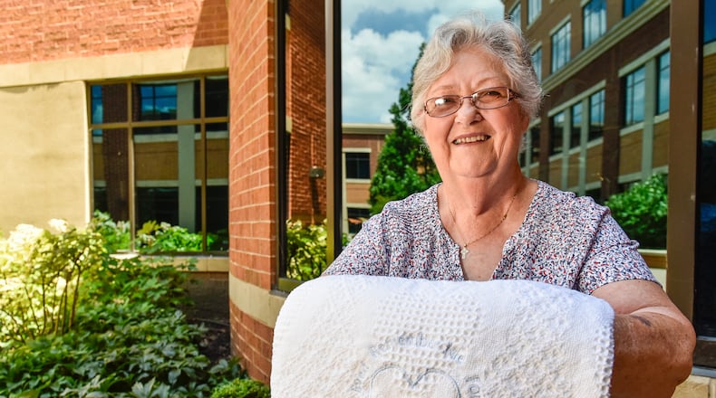 Atrium Medical Center wanted to create something for families to be able to take with them as a reminder of the generous act of their loved one to save others’ lives in their death by donating organs. Kathy Farler, with Thread Bear Designs, a volunteer with Atrium Medical Center has created a blanket that will be given to each of these families. Farler, who has operated her Middletown business for more than 20 years, embroiders these words on each blanket: “Remember me for the life I give for the life I’ve lived.” NICK GRAHAM/STAFF