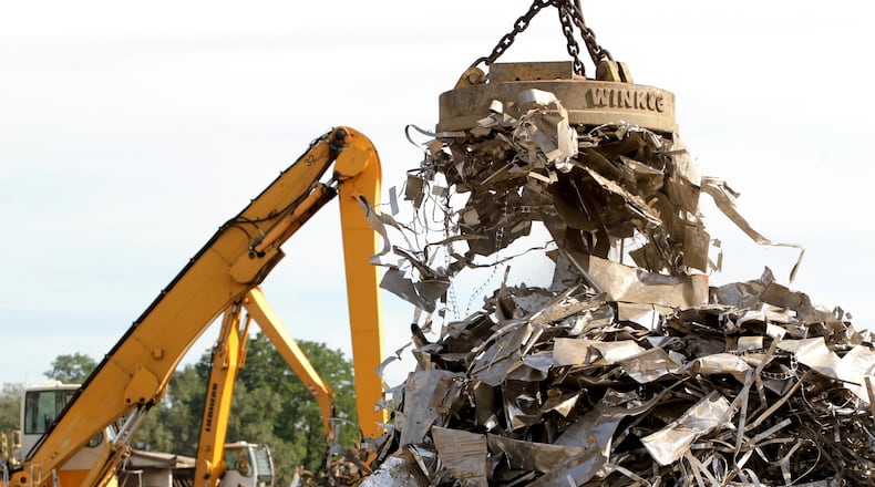 A large magnet is used to help sort material at Cohen Recycling in Middletown Thursday, Aug. 18, 2013. NICK DAGGY / STAFF