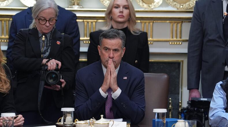 CIA Director John Ratcliffe, seated at center, and White House press secretary Karoline Leavitt, standing in back, listen during a cabinet meeting at the White House, Thursday, Jan. 29, 2026, in Washington. (AP Photo/Evan Vucci)