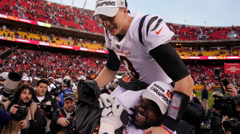 Cincinnati Bengals quarterback Joe Burrow (9) celebrates with teammate Tyler Shelvin at the end of the AFC championship NFL football game against the Kansas City Chiefs, Sunday, Jan. 30, 2022, in Kansas City, Mo. The Bengals won 27-24 in overtime. (AP Photo/Charlie Riedel)