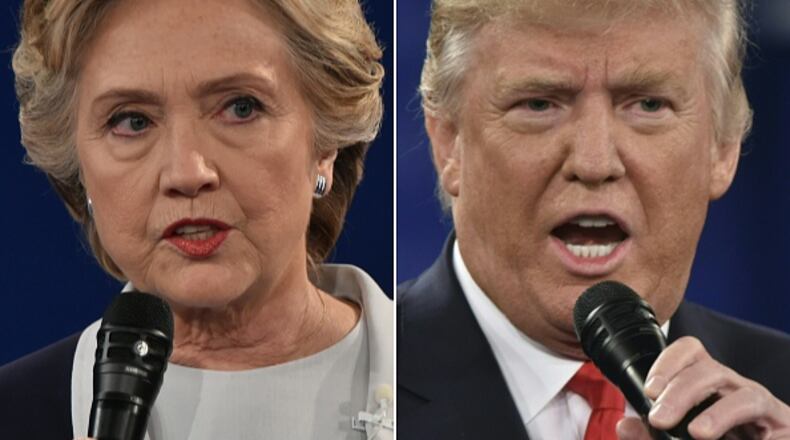 (COMBO) This combination of pictures created on October 09, 2016 shows Democratic presidential candidate Hillary Clinton and Republican presidential candidate Donald Trump during the second presidential debate at Washington University in St. Louis, Missouri on October 9, 2016. / AFP / Paul J. Richards (Photo credit should read PAUL J. RICHARDS/AFP/Getty Images)