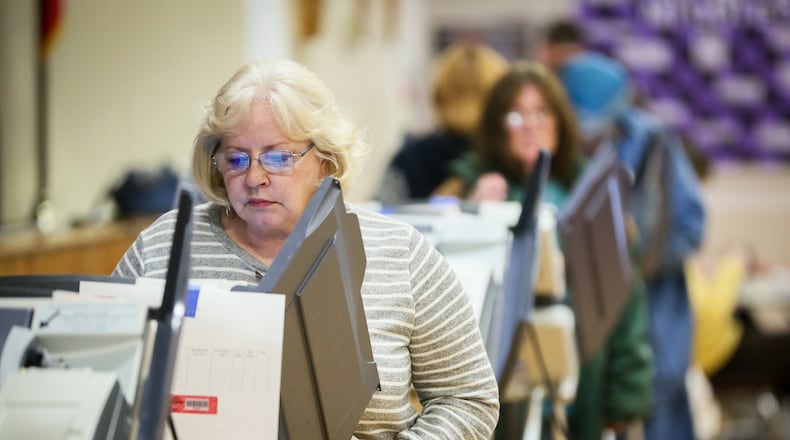 Lois Miller and others cast their votes at Amanda Elementary School in Middletown, Tuesday, Nov. 8, 2016. GREG LYNCH / STAFF