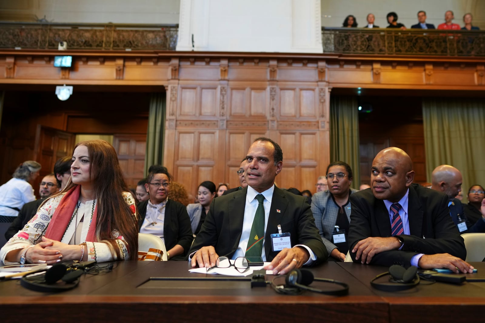 Ralph Regenvanu, center, Vanuatu's minister for climate change, arrives in the International Court of Justice, ahead of an advisory opinion on what legal obligations nations have to address climate change and what consequences they may face if they don't, Wednesday, July 23, 2025, in The Hague, Netherlands. (AP Photo/Peter Dejong)