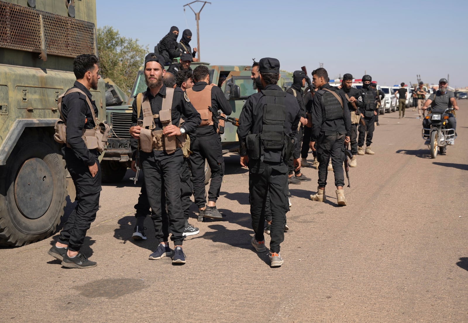 Syrian government security forces gather on the outskirts of Sweida province where clashes erupted between Druze militias and Sunni Bedouin clans, southern Syria, Monday, July 14, 2025. (AP Photo/Malek Khattab)