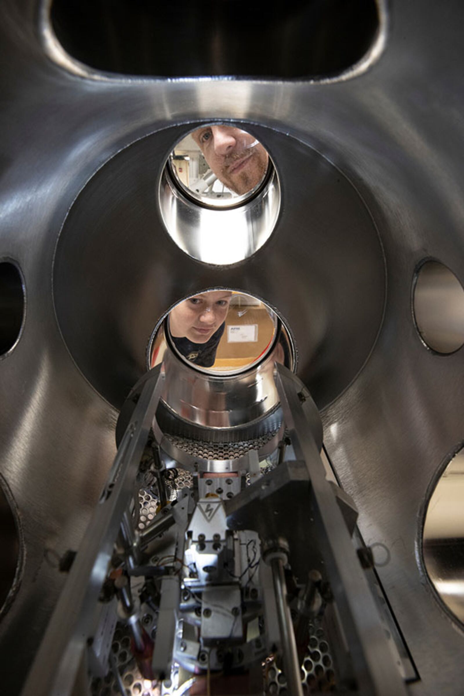 Perry Corbett and Sara McGinnis look through the recently donated ultra-high vacuum scanning tunneling microscope. PHOTO: JEFF SABO/CONTRIBUTED