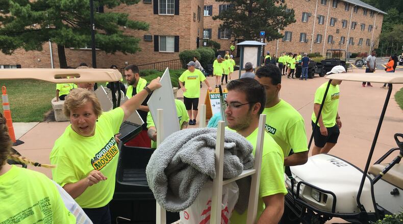 Wright State University faculty senate president Laura Luehrmann helps freshman students move into dorms in August 2019. Making the transition from high school to college can be difficult for some students. STAFF PHOTO / HOLLY SHIVELY