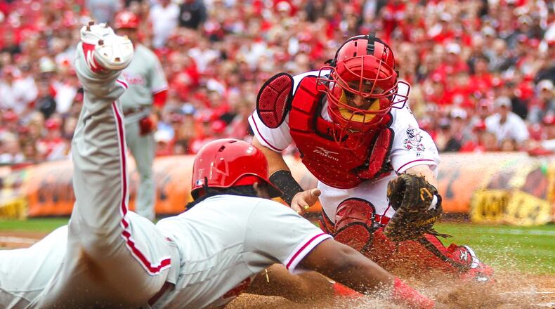 Reds catcher Tucker Barnhart barely misses a tag on Phillies baserunner Maikel Franco on a play at the plate during their Opening Day game, Monday, Apr. 3, 2017. GREG LYNCH / STAFF
