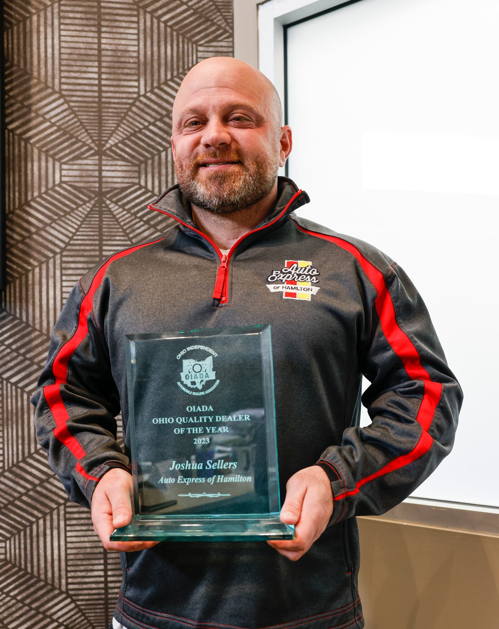 Josh Sellers, owner of Auto Express of Hamilton, is being recognized across the state and nationally for what he does for the community, which includes giving back, holding food drives, and backpack drives. NICK GRAHAM/STAFF