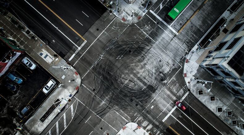 Tires mark the intersection of East Third and Jefferson Streets in downtown Dayton Tuesday January 17, 2023. Over the weekend, multiple vehicles did donuts in an activity called 'hooning'. JIM NOELKER/STAFF