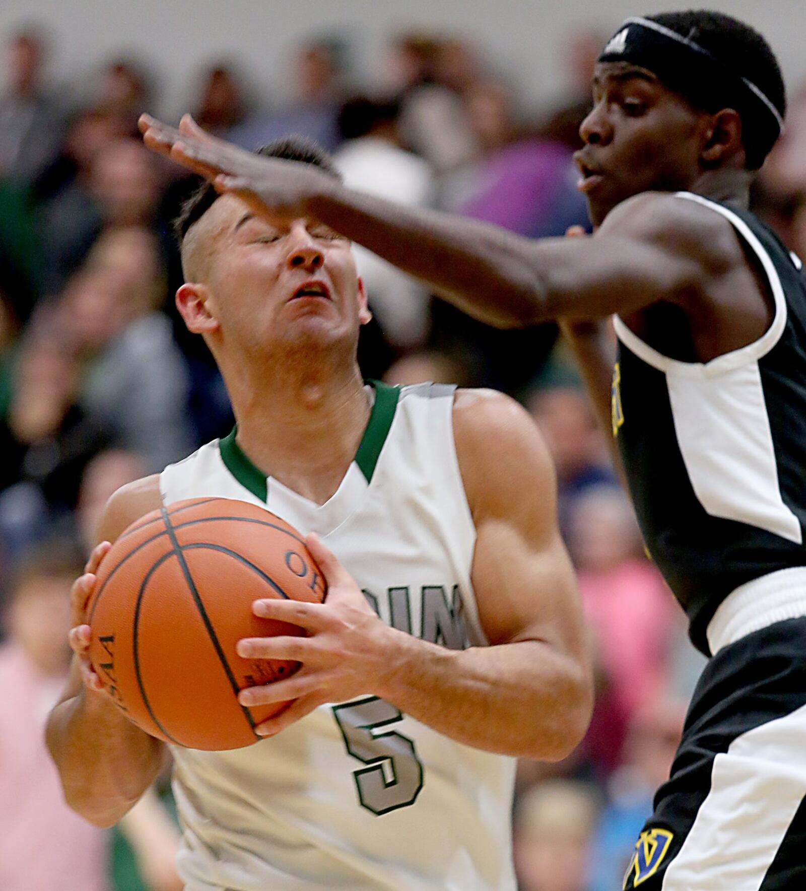 Badin guard Daunte DeCello runs into Northwest guard Ronnell Turner and scores two points during their game at Mulcahey Gym in Hamilton on Wednesday night. CONTRIBUTED PHOTO BY E.L. HUBBARD