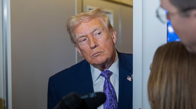 President Donald Trump speaks with reporters while in flight on Air Force One from his Mar-a-Lago estate in Palm Beach, Fla., to Joint Base Andrews, Sunday, Nov. 30, 2025. (AP Photo/Alex Brandon)