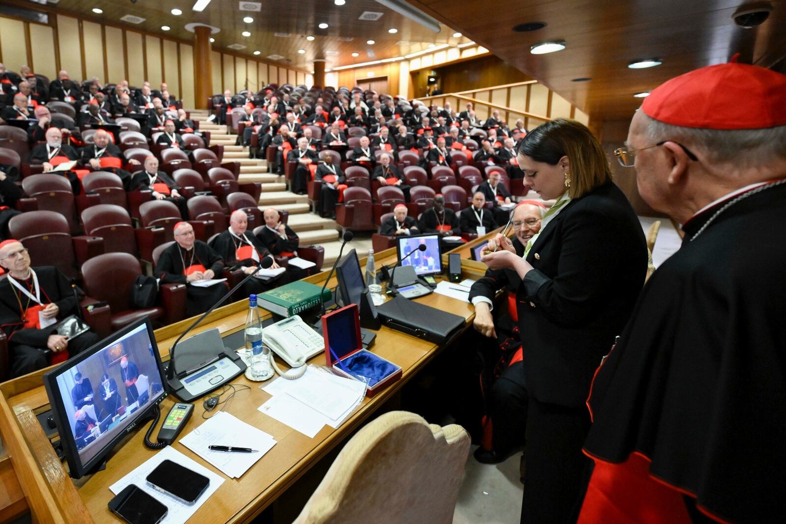 A Vatican employee annulls the papal seal on the pope's seal, at the Vatican, Tuesday, May 6, 2025. (Vatican Media via AP)