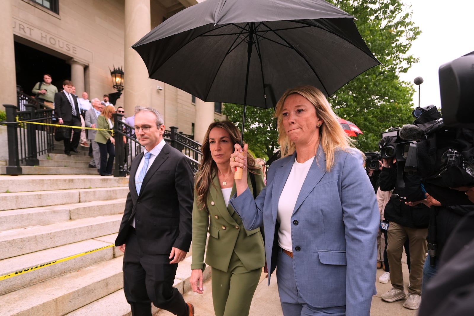 Karen Read, center, leaves Norfolk Superior Court for the day following jury deliberations at her trial, Tuesday, June 17, 2025, in Dedham, Mass. (AP Photo/Charles Krupa)