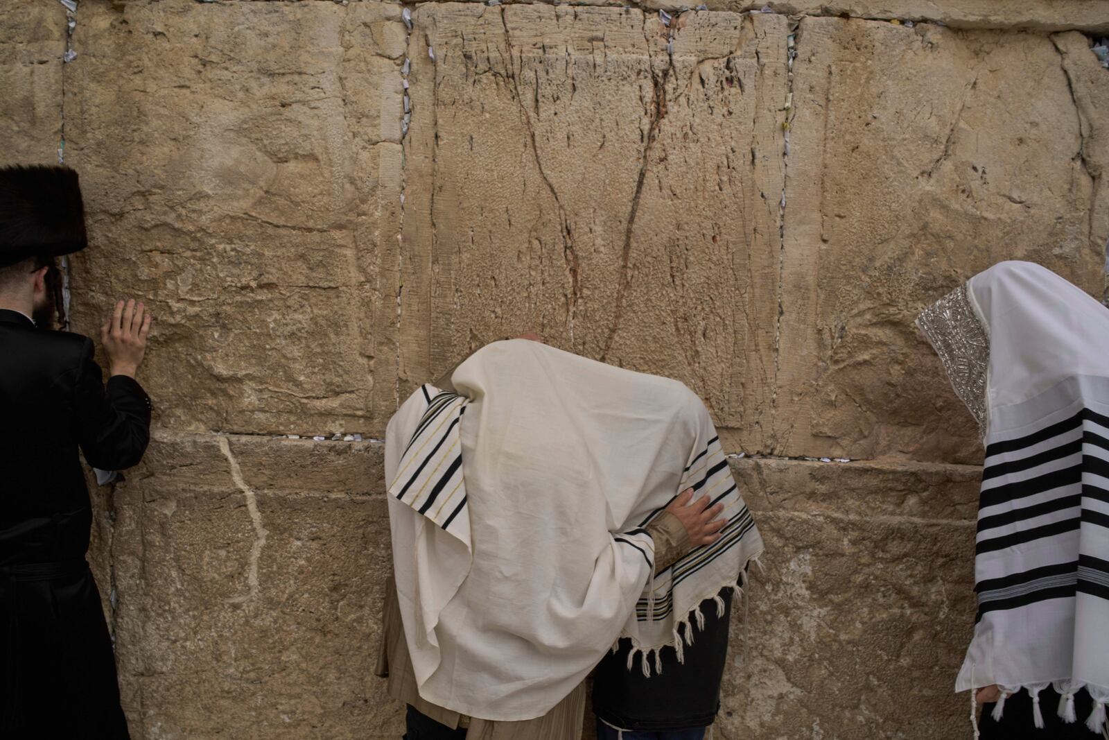 Covered in prayer shawls, Jewish men of the Cohanim Priestly caste participate in a blessing during the holiday of Passover, at the Western Wall, the holiest site where Jews can pray, in the Old City of Jerusalem, Tuesday, April 15, 2025. (AP Photo/Leo Correa)