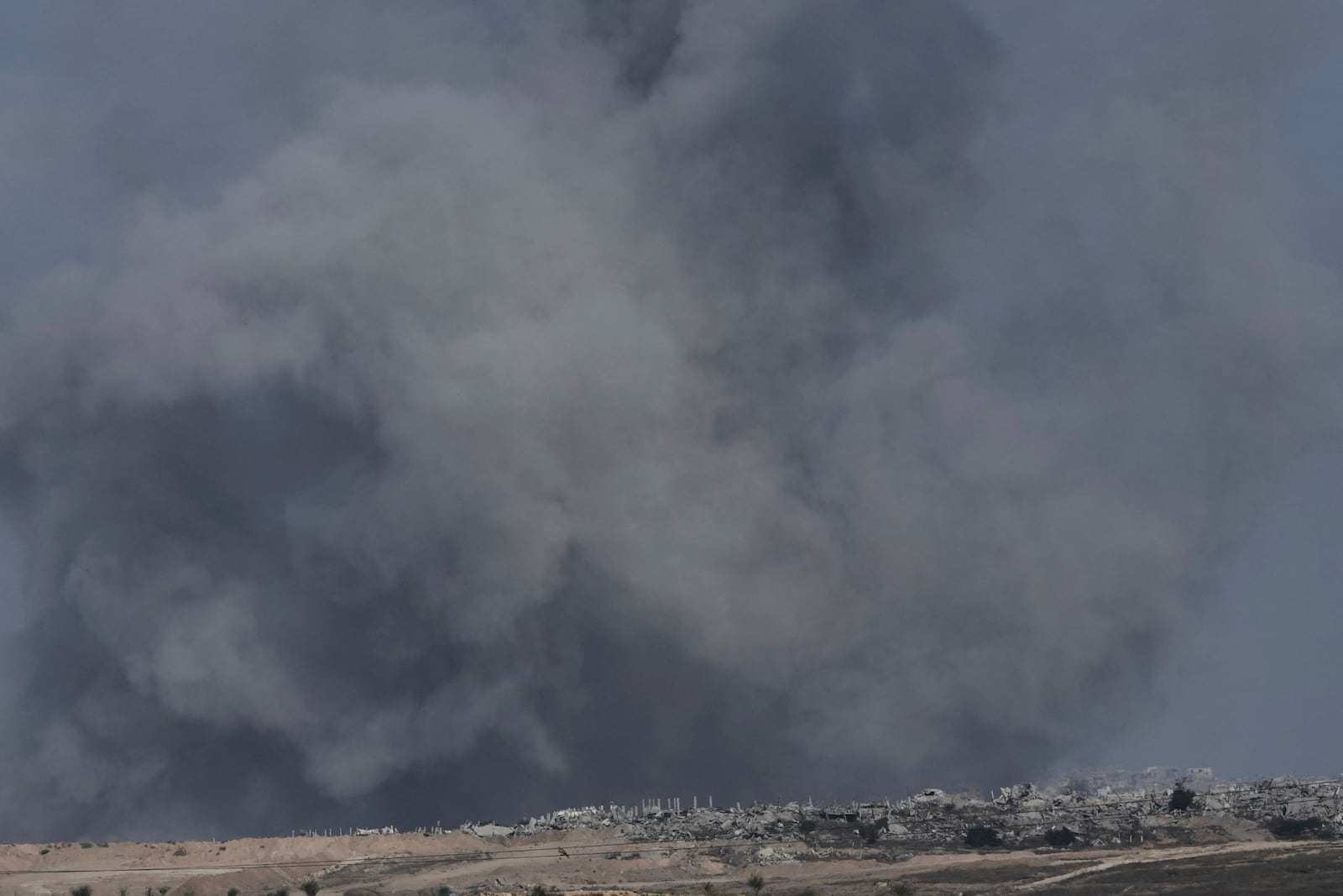 Smoke from Israeli bombardment of the northern Gaza Strip near the Israel-Gaza border, seen from southern Israel, Monday, July 14, 2025. (AP Photo/Maya Alleruzzo)