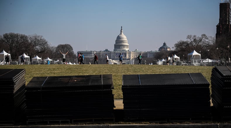 Temporary security fencing is stacked on the National Mall near the Capitol in Washington on Tuesday, Jan. 12, 2021, in advance of Inauguration Day. Security experts have warned that some far-right extremist groups have now started to focus attention on Inauguration Day and are already discussing an assault similar to the one on the Capitol last week. (Oliver Contreras/The New York Times)