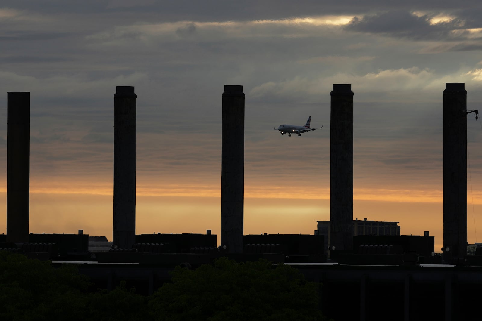 An airplane descends into landing at O'Hare International Airport in Chicago, Friday, May 23, 2025. (AP Photo/Nam Y. Huh)