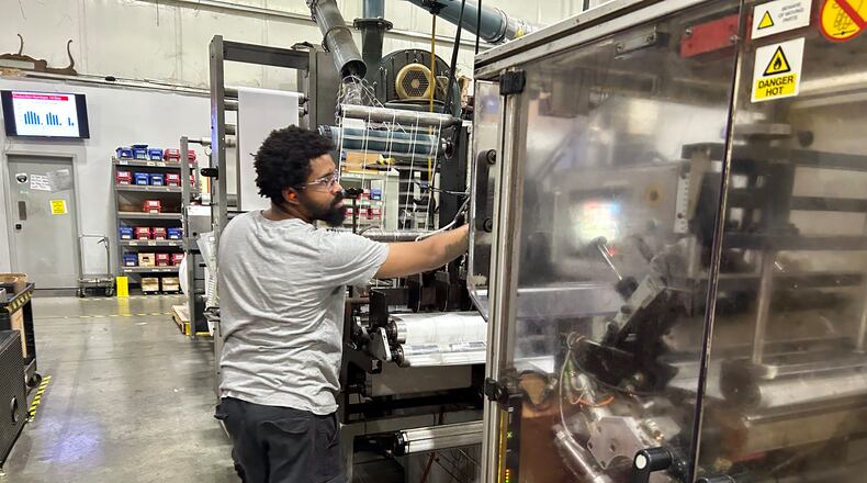 Brad Davis Jr., who has worked at Crane Consumables in Monroe for 10 years, operates one of the 17 machines in the massive warehouse. RICK McCRABB/CONTRIBUTOR