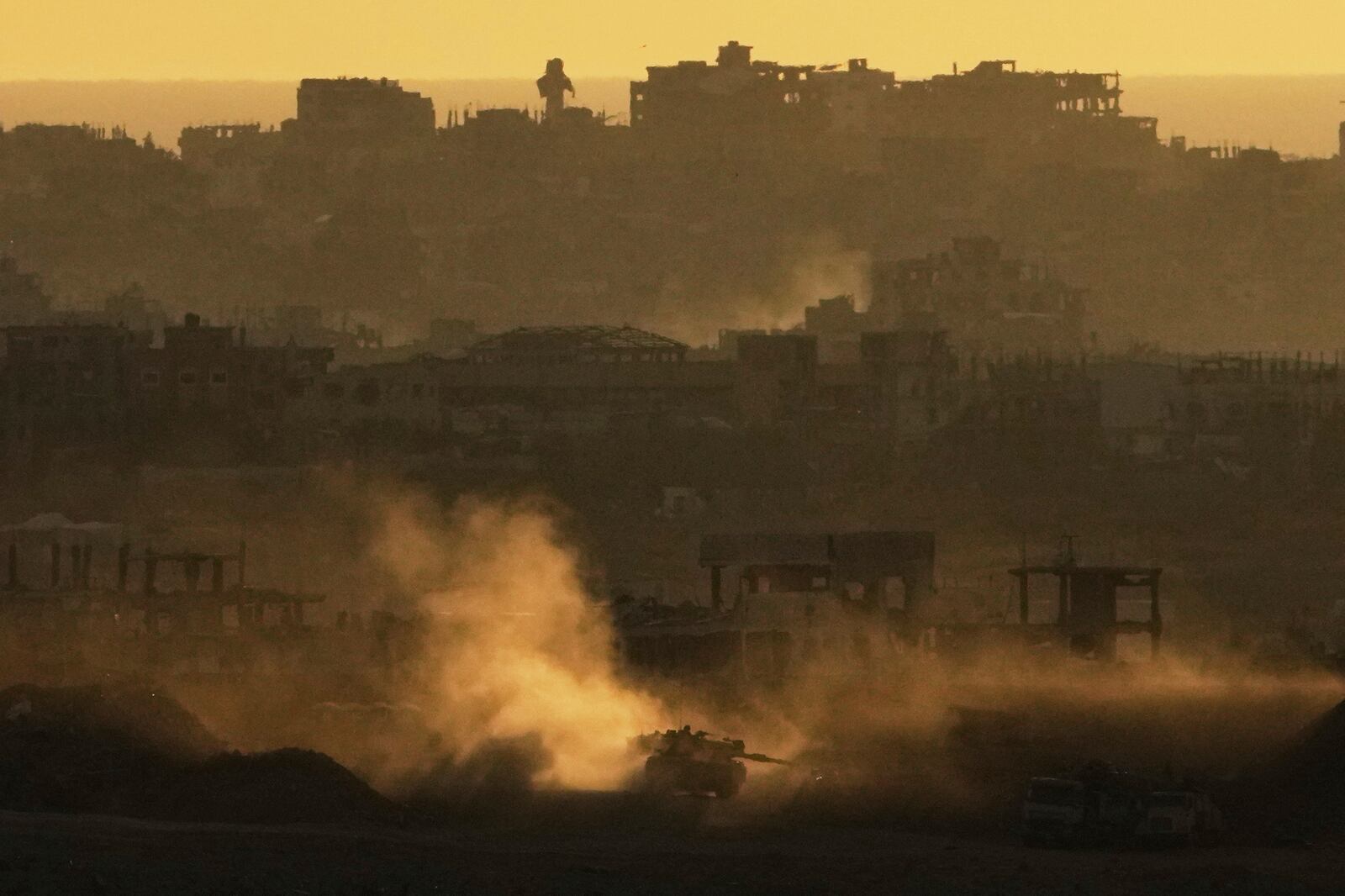 An Israeli army tank maneuvers in the Gaza Strip is seen from southern Israel, Sunday, May 4, 2025. (AP Photo/Ariel Schalit)