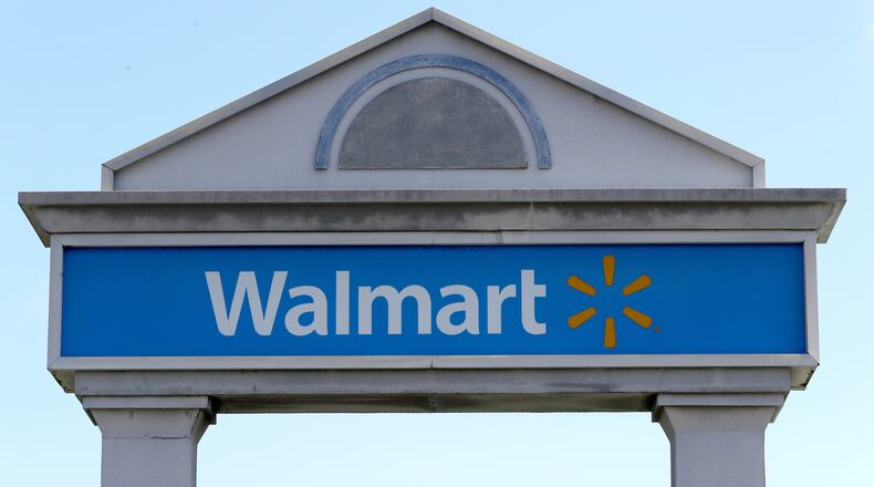 FILE - In this Tuesday, Sept. 3, 2019, file photo, a Walmart logo forms part of a sign outside a Walmart store, in Walpole, Mass. (AP Photo/Steven Senne, File)