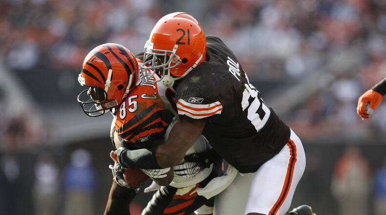 CLEVELAND - NOVEMBER 26: Defensive back Brodney Pool #21 of the Cleveland Browns tackles wide receiver Chad Johnson #85 of the Cincinnati Bengals at Cleveland Browns Stadium on November 26, 2006 in Cleveland, Ohio. The Bengals defeated the Browns 30-0. (Photo by Gregory Shamus/Getty Images)
