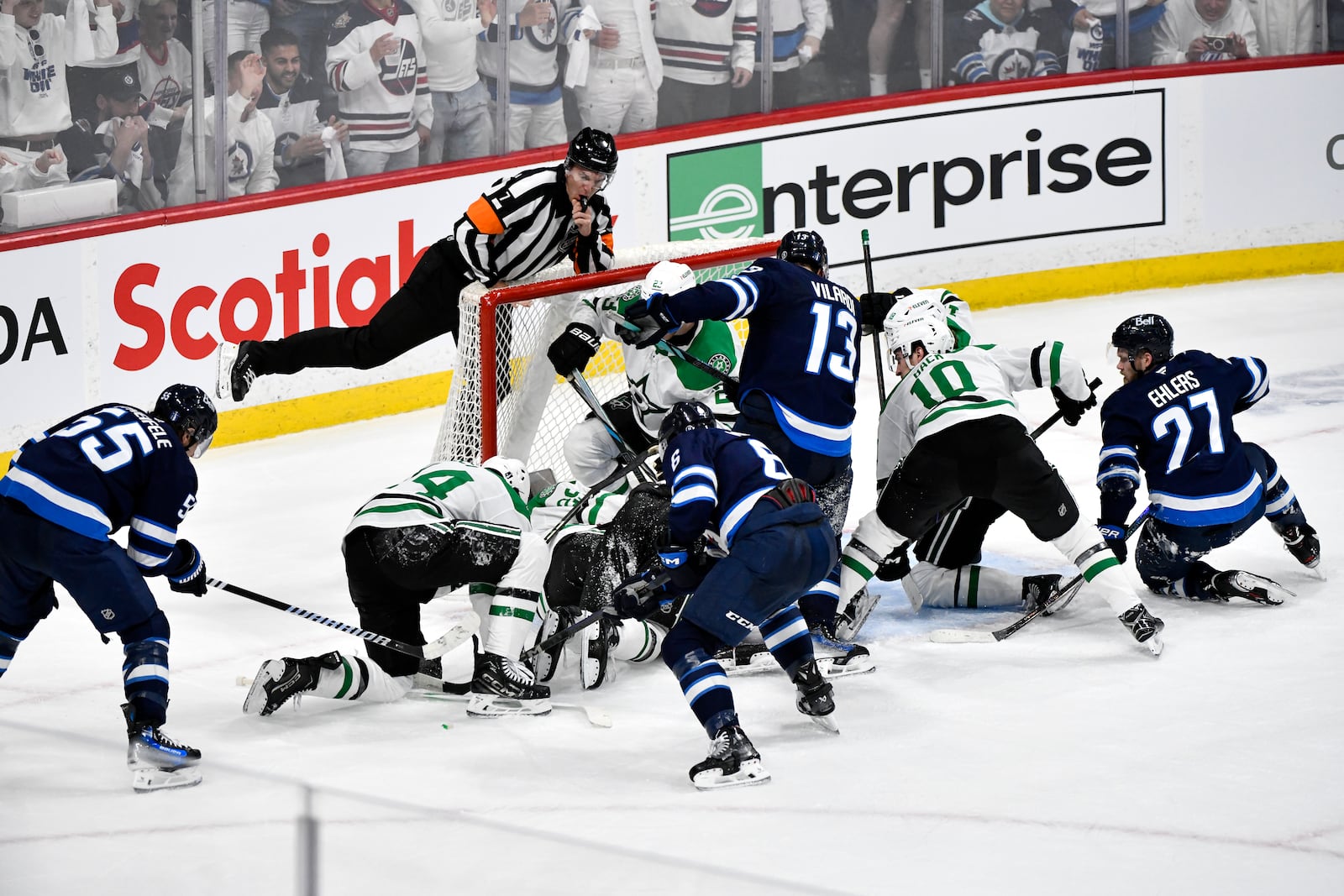 Winnipeg Jets players crowd the net around Dallas Stars goaltender Jake Oettinger trying to score in the last minutes of the third period NHL playoff hockey action in Winnipeg, Canada, Wednesday, May 7, 2025. (Fred Greenslade/The Canadian Press via AP)
