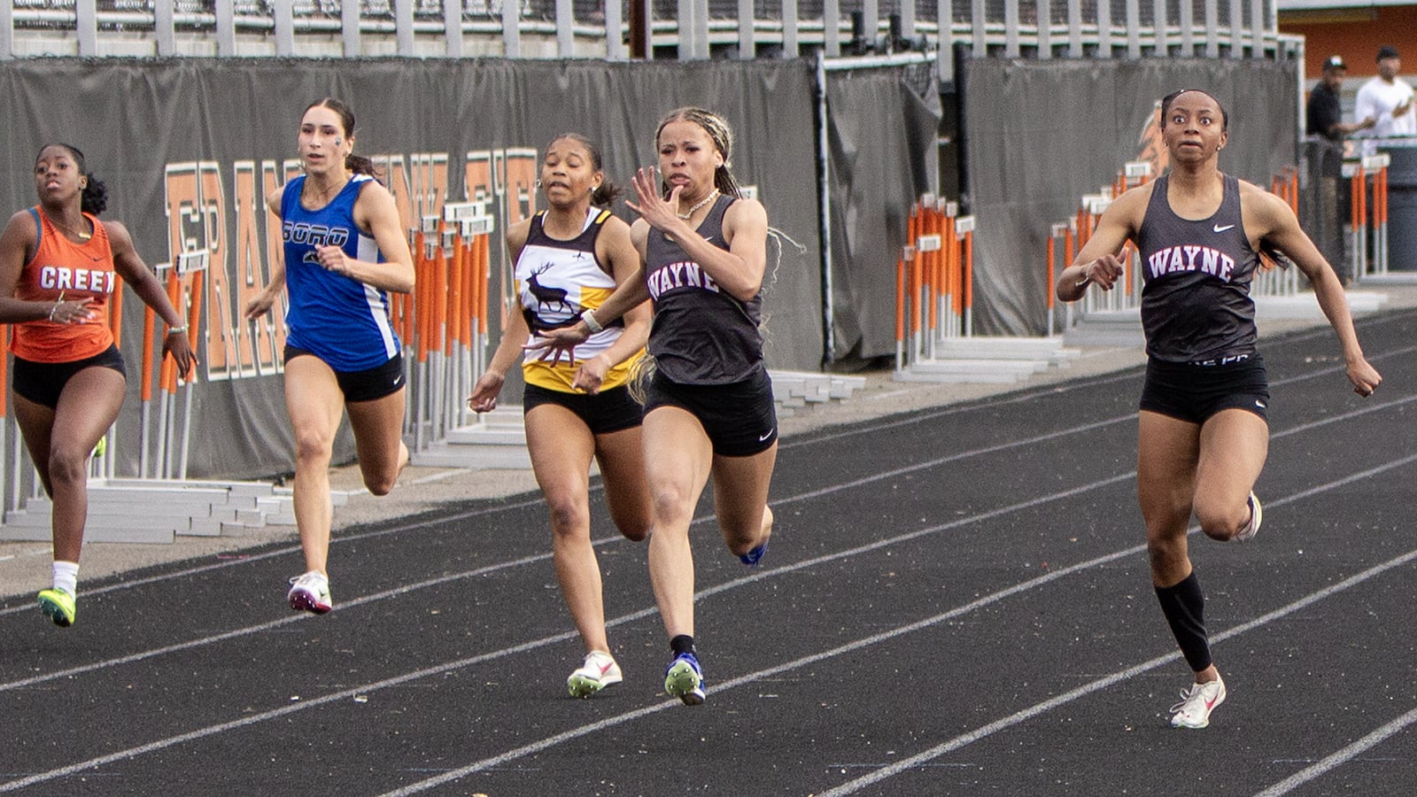 Wayne's Ric'Keya White (left) and Te'aira Branham-Patrick finish 1-2 in the 100 meters in 12.10 and 12.11 seconds at the GWOC meet Wednesday at Beavercreek High School. Jeff Gilbert/CONTRIBUTED