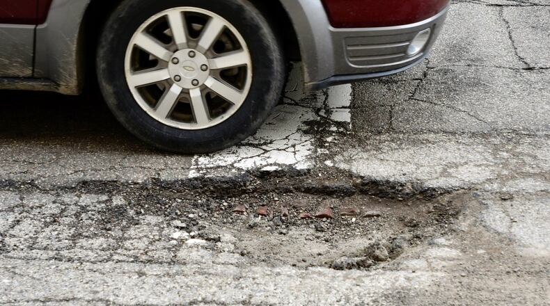 Rough weather causes craters on Central Avenue in Middletown.