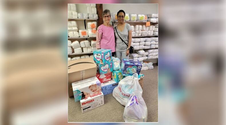 Linda O'Hara, left, and Ruth Hill of the "Harbour Town Village Bookies" book club recently donated more than 1,000 diapers to Chrysalis, a Hamilton organization that distributes food and clothing to families. PROVIDED