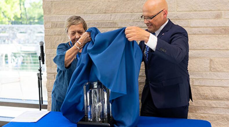 More than a half-century after the historic Civil Rights voter registration in the then segregated American south, the president of Miami University recently presented the school’s annual freedom award to the alumnae association of one of the school’s innovative and ahead of its time campuses. Miami officials described the award ceremony as a “a full circle moment” as President Gregory Crawford presented the Freedom Summer of ‘64 Award to the Western College Alumnae Association, represented by WCAA President Ann Walton, left, as they together unveiled the award during a ceremony earlier this month. RICARDOTREVINOJR/CONTRIBUTED